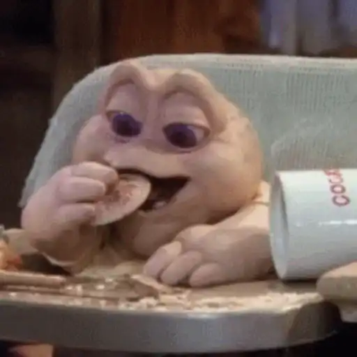 Figurinha: Bebê Dinossauro comendo biscoito